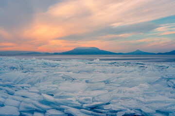 Fonyod, Hungary - Beautiful icebergs on the shore of the frozen Balaton. Badacsony and Gulacs with...