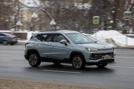 car JAC JS4 driving fast on city street with blurred background. Moskvitch 3 crossover in motion on winter motorway