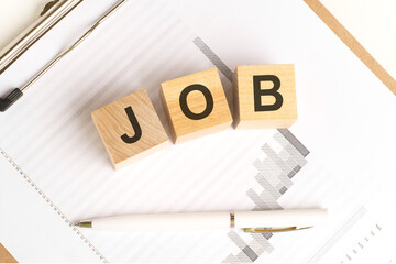 wooden blocks with the word JOB stand on financial background with chart and pen, business concept