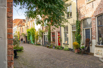 Fototapeta premium an old brick building sitting next to green trees in a city