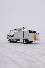 Aircraft deicer on the runway at a snowy airport
