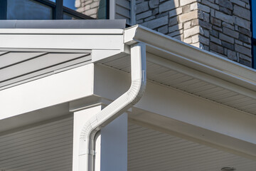 White frame gutter guard system, with white horizontal and vertical vinyl siding fascia, drip edge,...