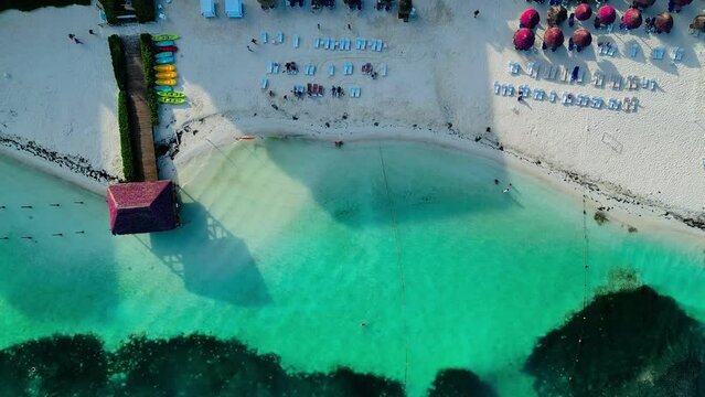 Vista aerea de la playa en un hotel con camastros en el mar turquesa del caribe Mexicano en canc&uacute;n