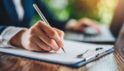 woman's hand gracefully writing on paper with pen, expressing creativity and thoughtful reflection