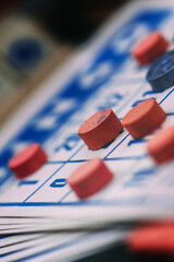 Close-up View of a Bingo Card and Red Markers During a Game Session