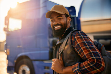 Happy African American truck driver looking at camera.