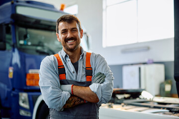 Portrait of confident truck repair shop owner looking at camera.