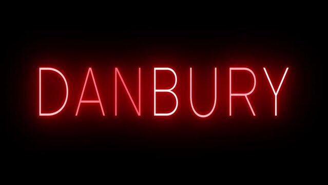 Flickering red retro style neon sign glowing against a black background for DANBURY