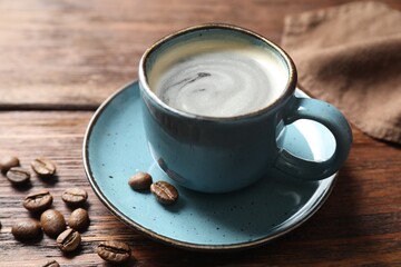Turkish coffee. Freshly brewed beverage and beans on wooden table, closeup