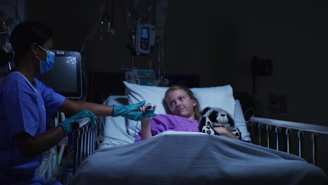 A black nurse is helping child patient in the hospital with everything