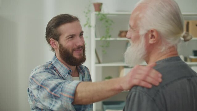 Family conversation: young and elderly men talk about life, psychological support for each other, cross-generational dialogue, heartfelt consolation, advice and wisdom, warm communication