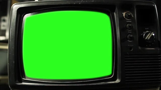 An Old TV Turning On Green Screen with Static Noise. Close Up. You can replace green screen with the footage or picture you want with “Keying” effect in After Effects.