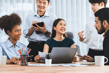 Happy diverse business people work together, discussing in corporate office. Professional and diversity teamwork discuss business plan on desk with laptop. Modern multicultural office worker. Concord