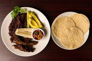Roasted pork with avocado and tortillas