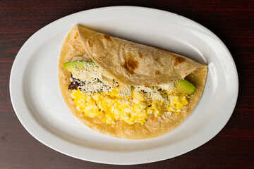 Honduran tortilla with eggs, avocado, meat and cheese