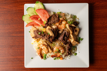 Sauteed shrimp, chicken and pork over rice