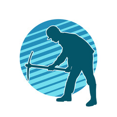 Silhouette of a man in worker costume carrying pick axe tool in action pose. Silhouette of a miner in action pose with pick axe tool.