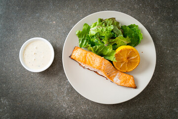 fried salmon steak with lemon and vegetable
