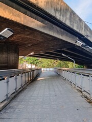 a pedestrian walkway under an expressway