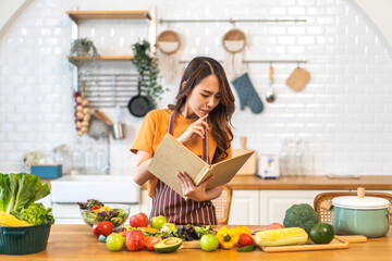 Portrait of beauty body slim healthy asian woman eating vegan food healthy with fresh vegetable salad in kitchen at home.diet, vegetarian, fruit, wellness, health, green food.Fitness and healthy food