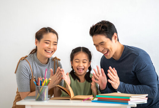 Portrait happy love asian family mother teach little daughter asian girl learn and study.Mom and asian young girl reading book and pencil making lessons in homeschool at home.Education