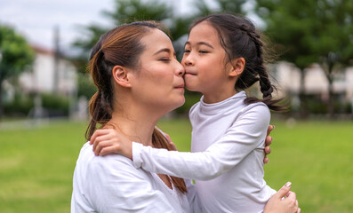 Fototapeta premium Portrait of enjoy happy love asian family mature mother and girl daughter smiling play and having fun together, mom, mother day, care, kid, child.happy family in moments good time at home