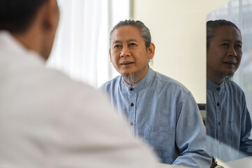 Asian man doctor service help support discussing and consulting talk to asian sick senior man patient at meeting health medical care trust concept in hospital.healthcare and medicine