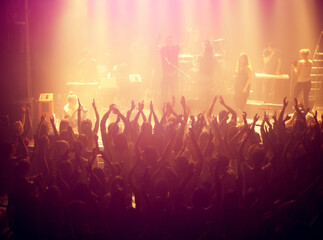 Concert, audience and rock music with hands up from people at dj, band and festival event at a...