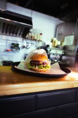 Prepared delicious fresh fragrant golden burger with meat cutlet placed on a table in plastic tray . High quality photo