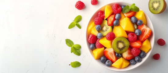 Bowl of healthy fresh fruit salad on white background