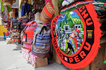 Souvenir shops with colorful Peruvian handmade arts and crafts in Tourist market in downtown Peru,...