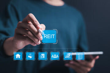 Reit, Real estate investment trust concept, Businessman use tablet with virtual reit icons for real estate management that generates continuous income. - obrazy, fototapety, plakaty