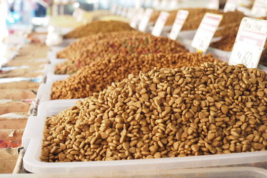 stack of dried cat food display for sale at local market 