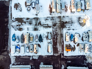 Drone view of camper, mobile home, and boat winter storage.
