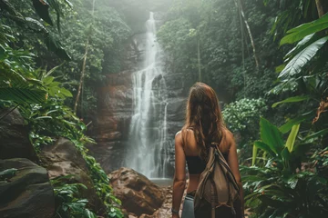 Schilderijen op glas latina girl looking at a waterfall hidden in the jungles. concept of adventure. © Centric 