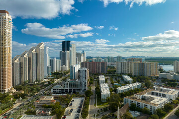 High angle view of Sunny Isles Beach city with expensive highrise hotels and condo buildings on Atlantic ocean shore. American tourism infrastructure in coastal southern Florida