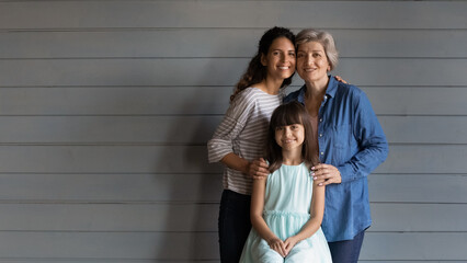 Photo portrait of three beautiful females of diverse generations one hispanic family. Preteen kid...