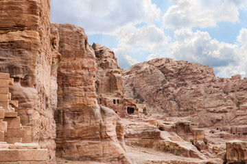 The main fasade of the Great Temple with the man made caves carved into the rocks in the Nabatean...