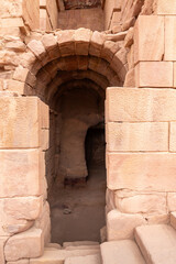 The arched entrance made of the large stones to the main fasade of the Great Temple in the Nabatean Kingdom of Petra in the Wadi Musa city in Jordan