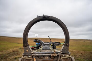 quad bike with a crush protection rollbar installed for safety in australia. australian motorbike in a field on a farm © Phoebe