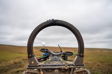 quad bike with a crush protection rollbar installed for safety in australia. australian motorbike in a field on a farm