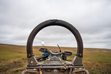 quad bike with a crush protection rollbar installed for safety in australia. australian motorbike in a field on a farm © William