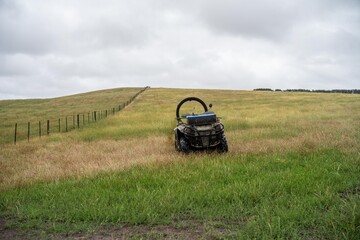 quad bike with a crush protection rollbar installed for safety in australia. australian motorbike in a field on a farm © William