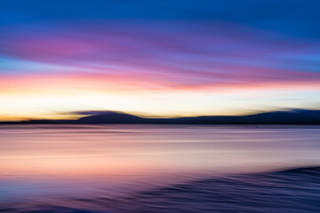 Fototapeta na wymiar Background sunset intentional camera movement effect soft hues on morning light blue hour.