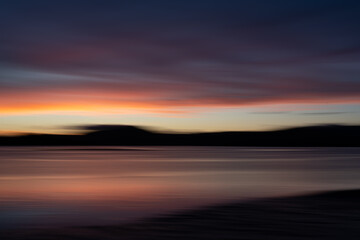 Fototapeta na wymiar Background sunset intentional camera movement effect soft hues on morning light blue hour.