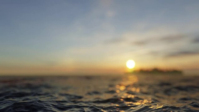 Sea waves in the foreground and the morning sun with an island in the background in bokeh effect, 3D render