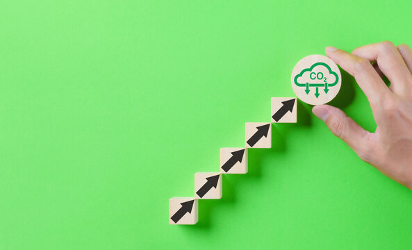 Hand placed CO2 reduction icon with arrow up for decrease CO2. Net zero and carbon neutral, Carbon emissions, CO2 reduce, Sustainable energy, Climate change, Carbon footprint, environmental problem,