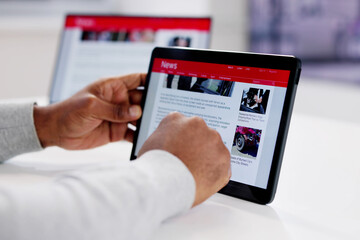Reading Newspaper Article On Tablet
