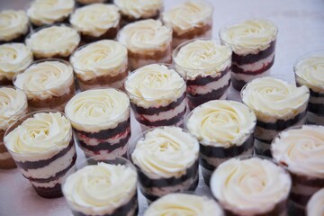 Confectionery for the festive table. Dessert with cream and pastries in a glass