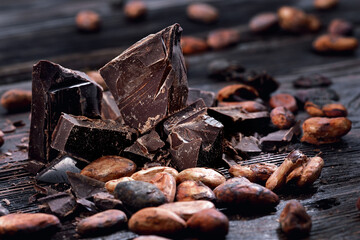 Broken dark chocolate and coffee beans on a table
